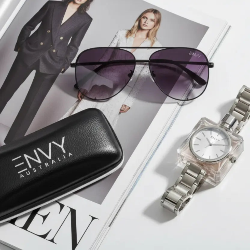 Black Fade Sunglasses and watch with Envy Australia case on a magazine