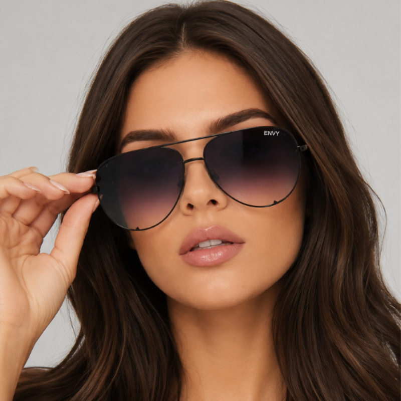 Woman wearing Black Fade dark sunglasses with a neutral background