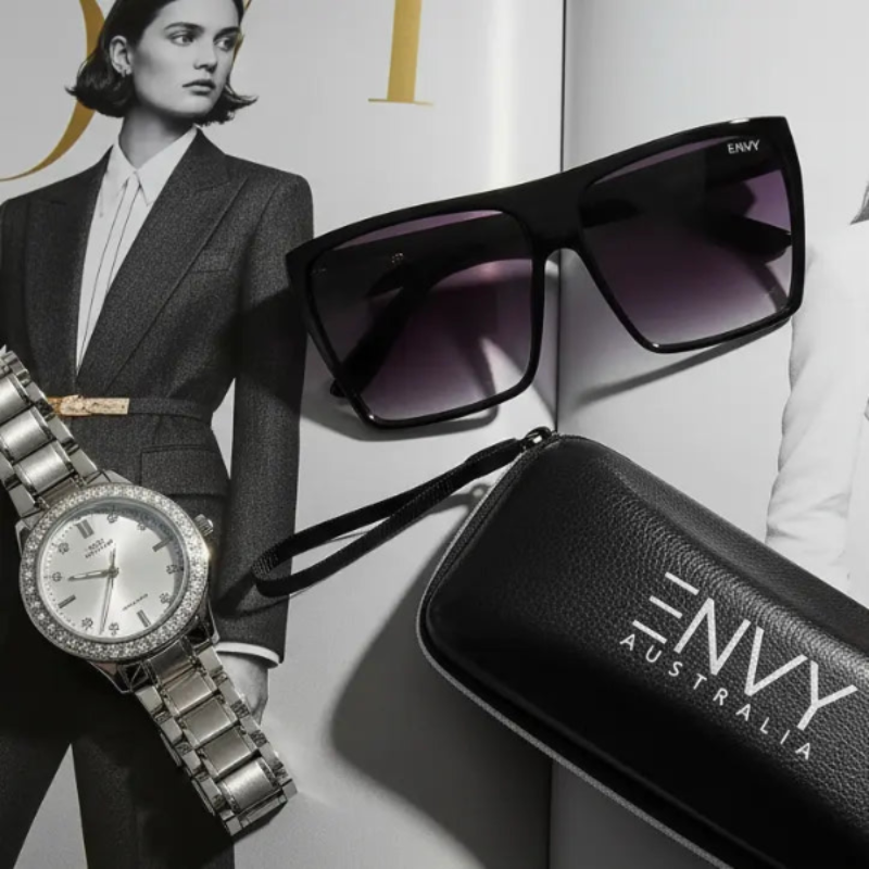 Envy Luxe Black Sunglasses and watch with Envy Australia case on a magazine cover background