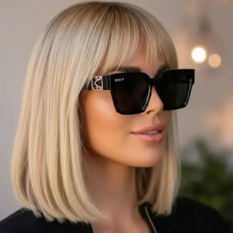 Person wearing London Look black ENVY sunglasses with a blurred background