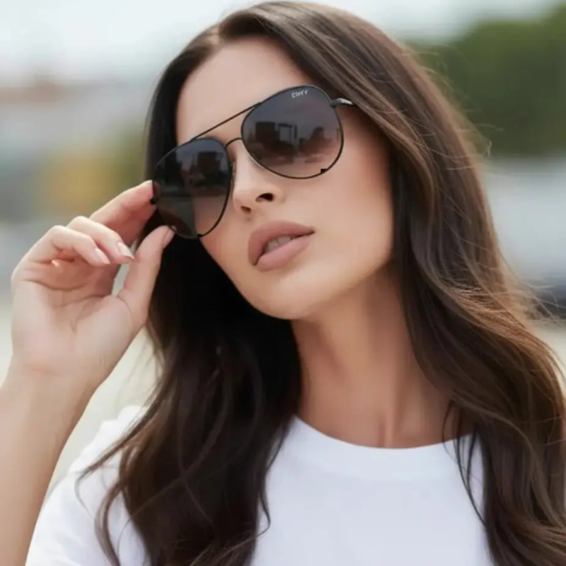 Woman wearing Envy Ombre PIlot Black sunglasses with a blurred background