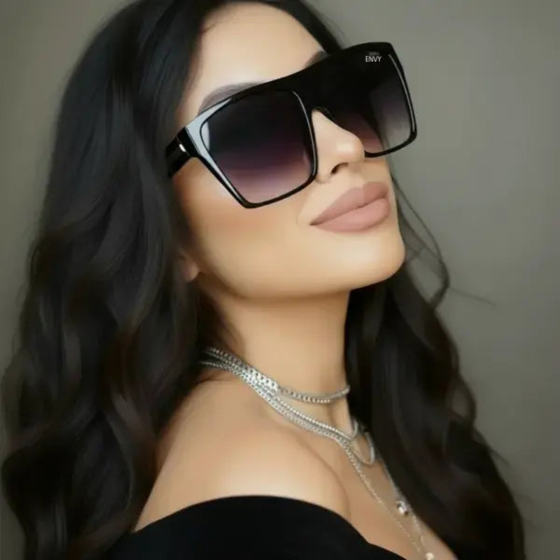 Woman wearing Sachi black sunglasses with a neutral background