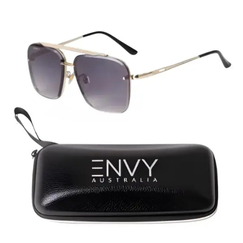 A pair of Midnight Rebel square aviator-style sunglasses with gold metal frames and dark gray gradient lenses, shown above a black zippered hard case printed with the brand name 'ENVY AUSTRALIA'.