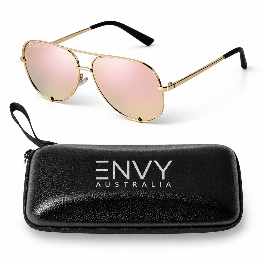 A pair of aviator-style sunglasses with gold metal frames and rose gold mirrored lenses, called Mirror Shine, shown above a black zippered hard case printed with the brand name ENVY AUSTRALIA.