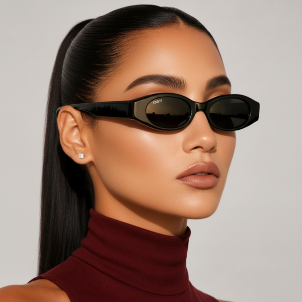 Woman wearing black sunglasses with a neutral background